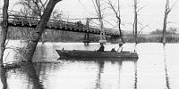 23 1922 Flood Ernest Fendorf's motor boat under Suspension Bridge