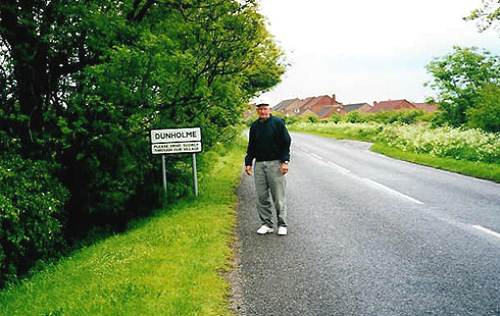 Bob Tyler by sign for Dunholme taken in 2000