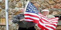 22 Brice and Royal Kallenbach raising new flag at Grand Reopening Ceremony