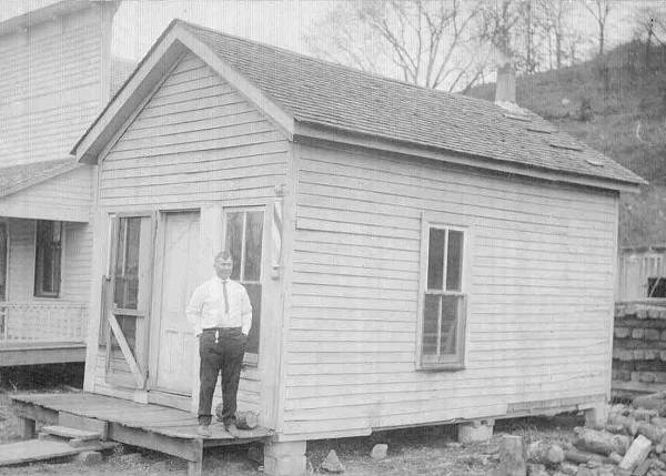 38 Herb Carrender standing at building next to Barber Shop in Tuscumbia