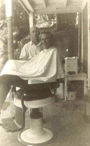 05 Wes Condra giving Charles Webb a haircut on Hauenstein's porch during Flood