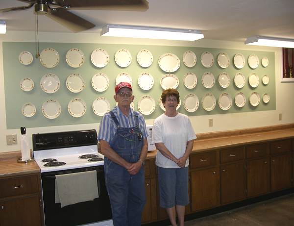26 Harold Flaugher and Doris Wiggins posing in front of Wall Display