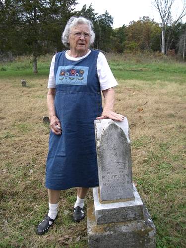 21 Elva Boyd Steen standing next to tombstone of Her Great Great Grandmother