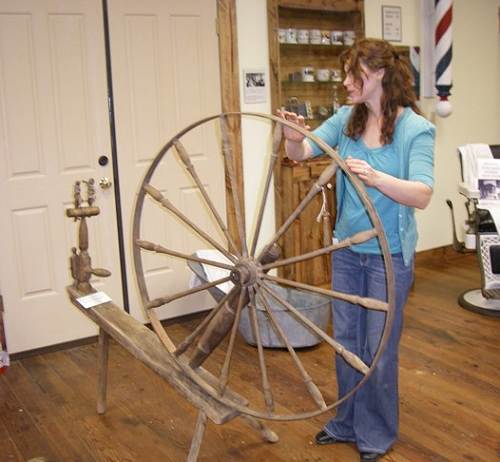 26 Samantha Inspecting Spinning Wheel