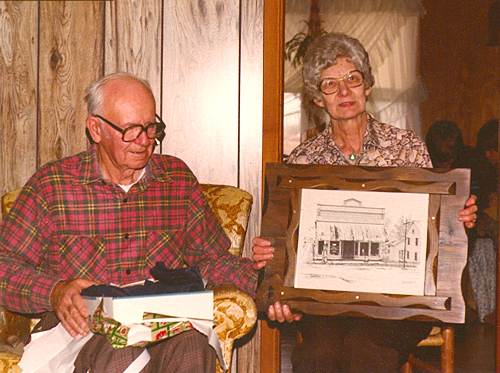 14 Clem and Martha with Picture of Store