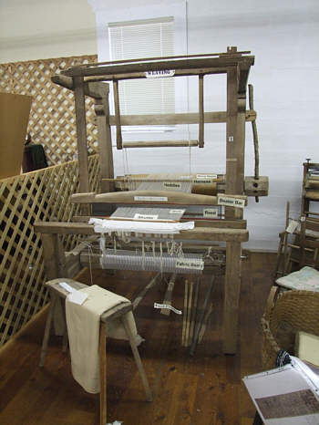 This loom, from the weaving cabin, is on display in our museum.